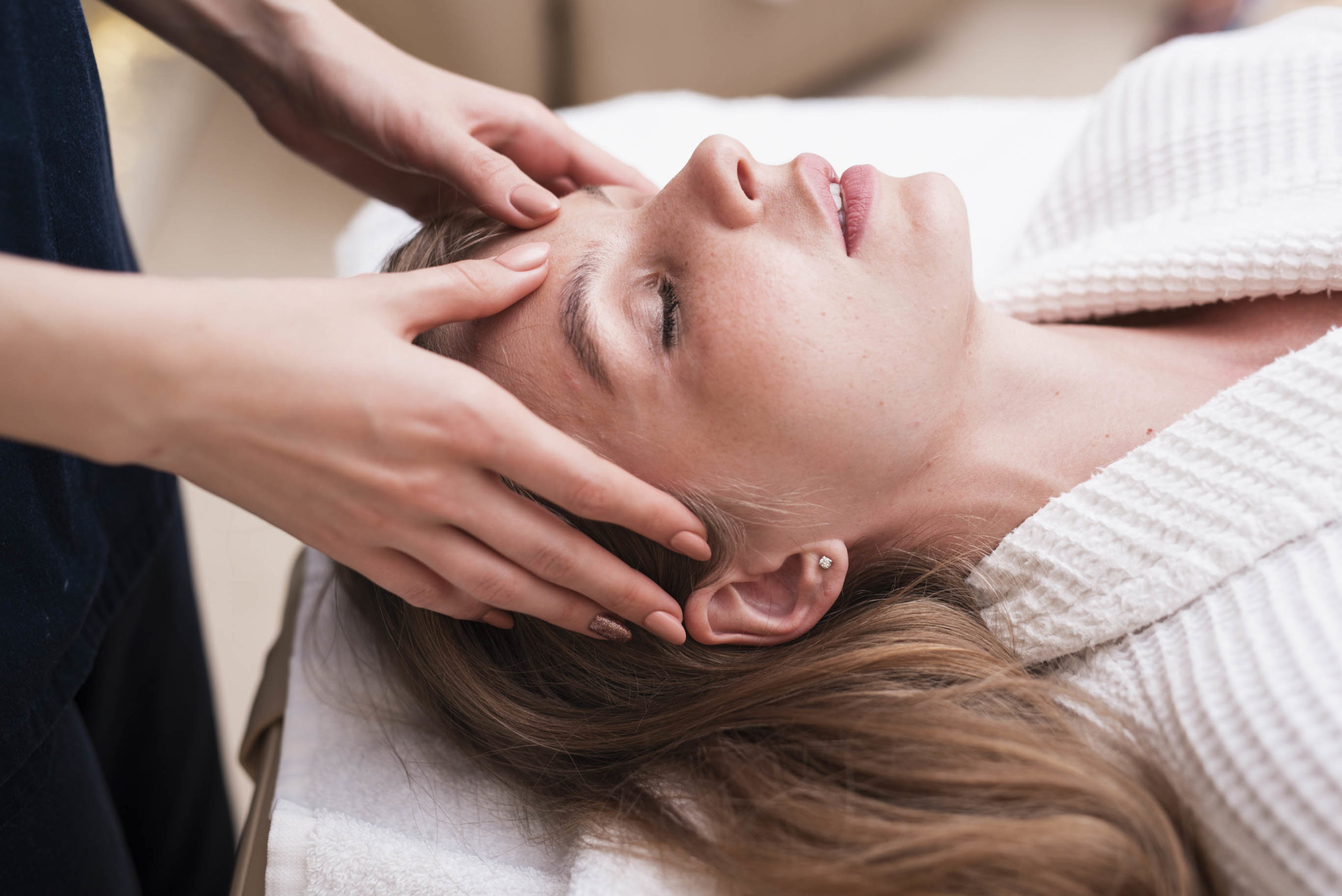 kopfmassage-auf-entspannte-frau-im-spa